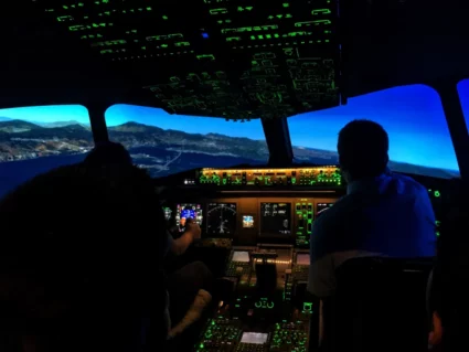 Airline pilot candidates flying an airplane simulator
